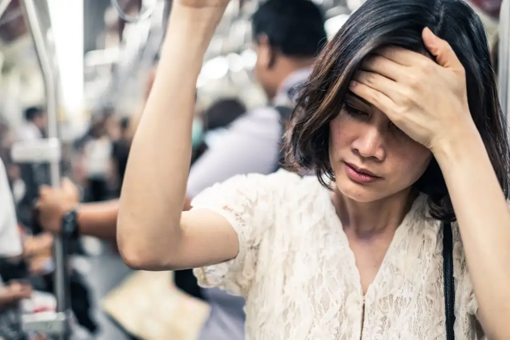Woman who needs anxiety treatment in a train.
