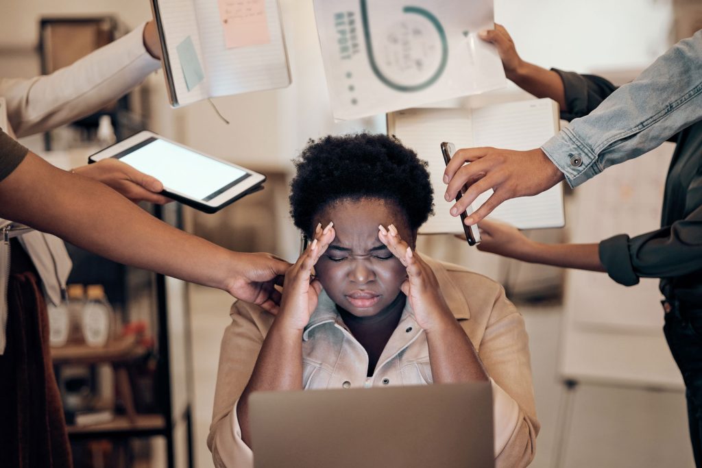 Stressed woman with lots of workloads in office.