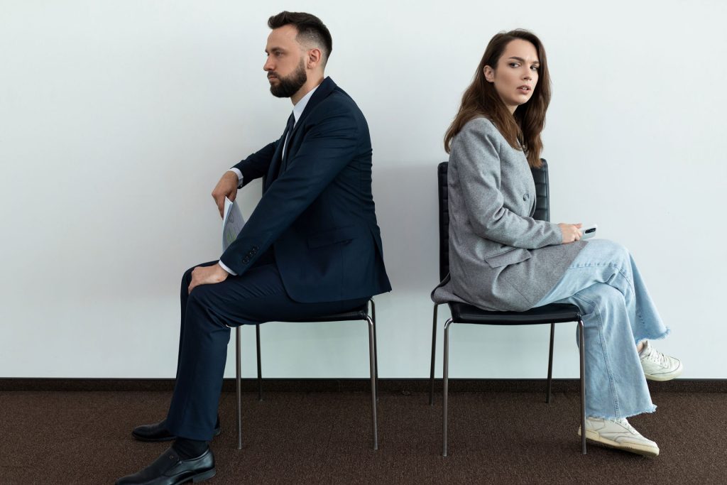 Man and woman sits separately and annoyed.