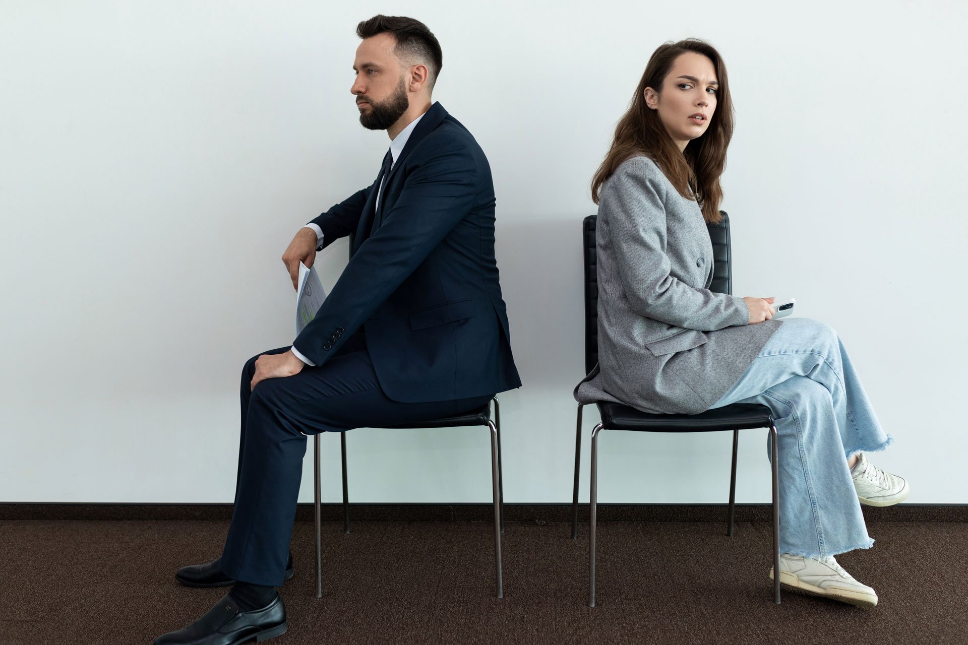 Man and woman sits separately and annoyed.