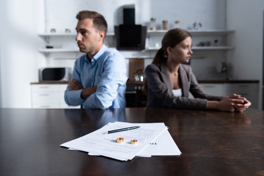 Couples and divorce papers with rings.