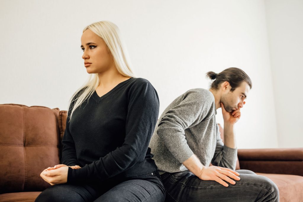 Couples sitting back to back and angry.
