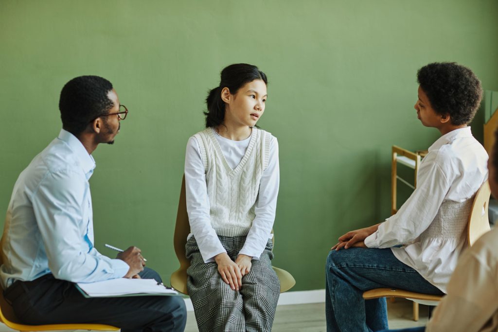 Young asian girl talking to her parents.