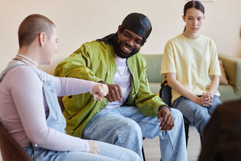 Group of people sitting in a circle.
