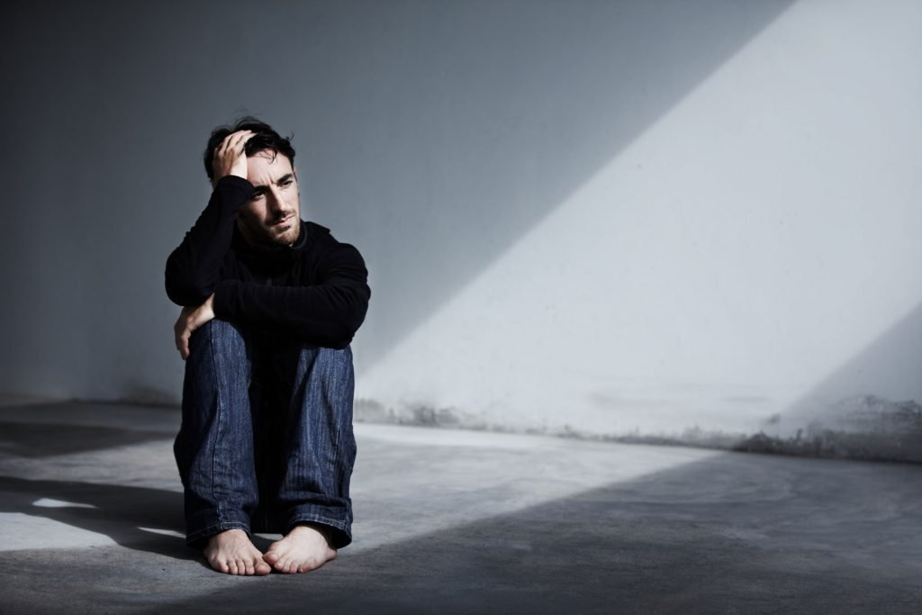 depressed man sitting.