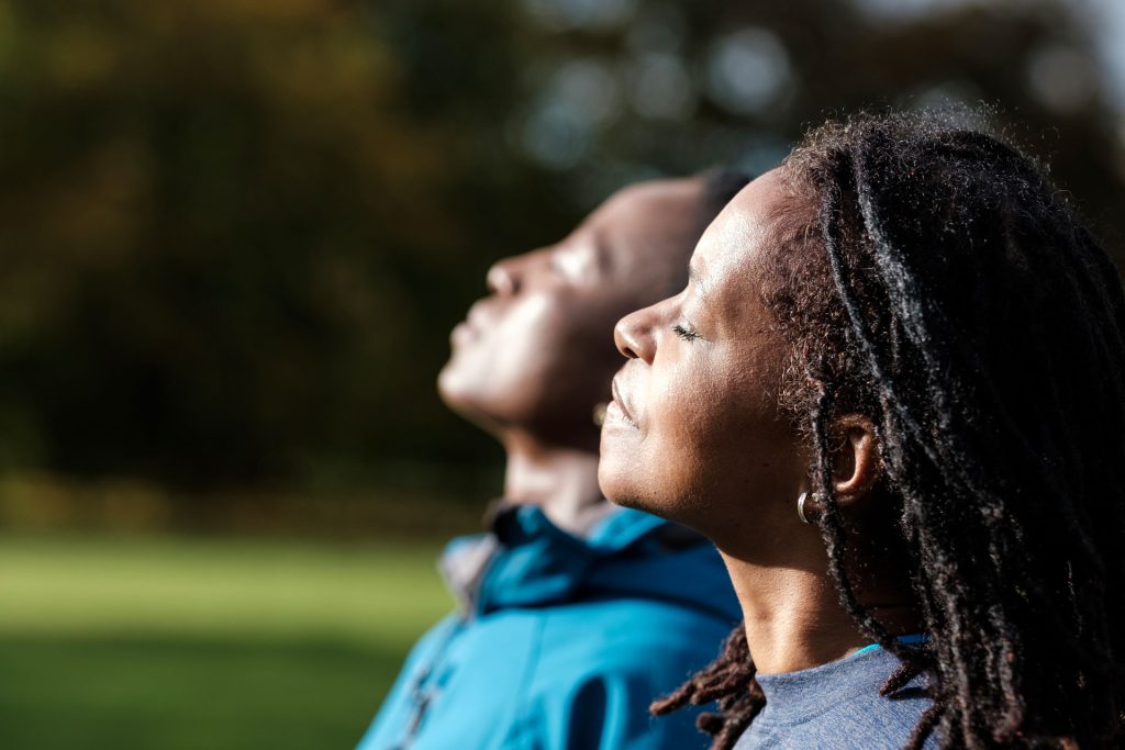 Portrait of two women enjoying the sun.