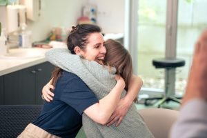 Woman hugging her friend.