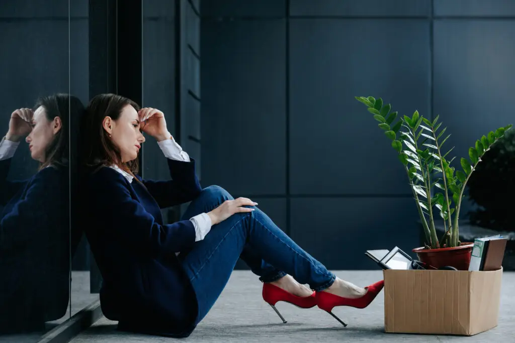 Woman sitting outside office.