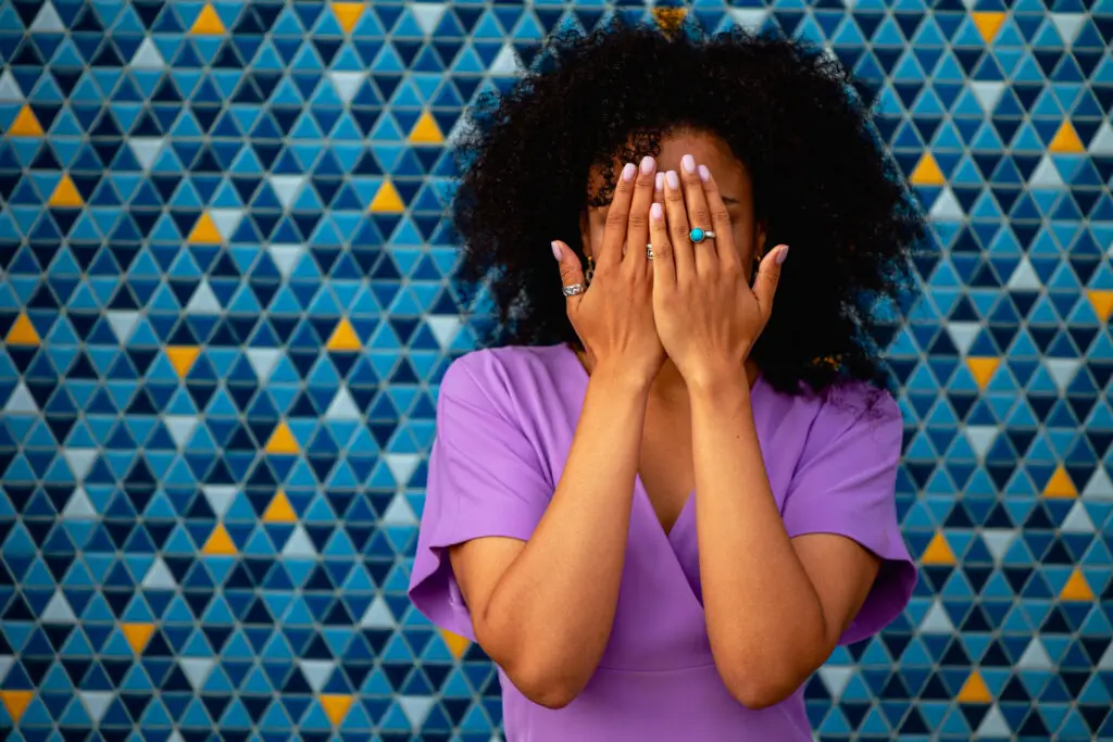 Woman covering face.