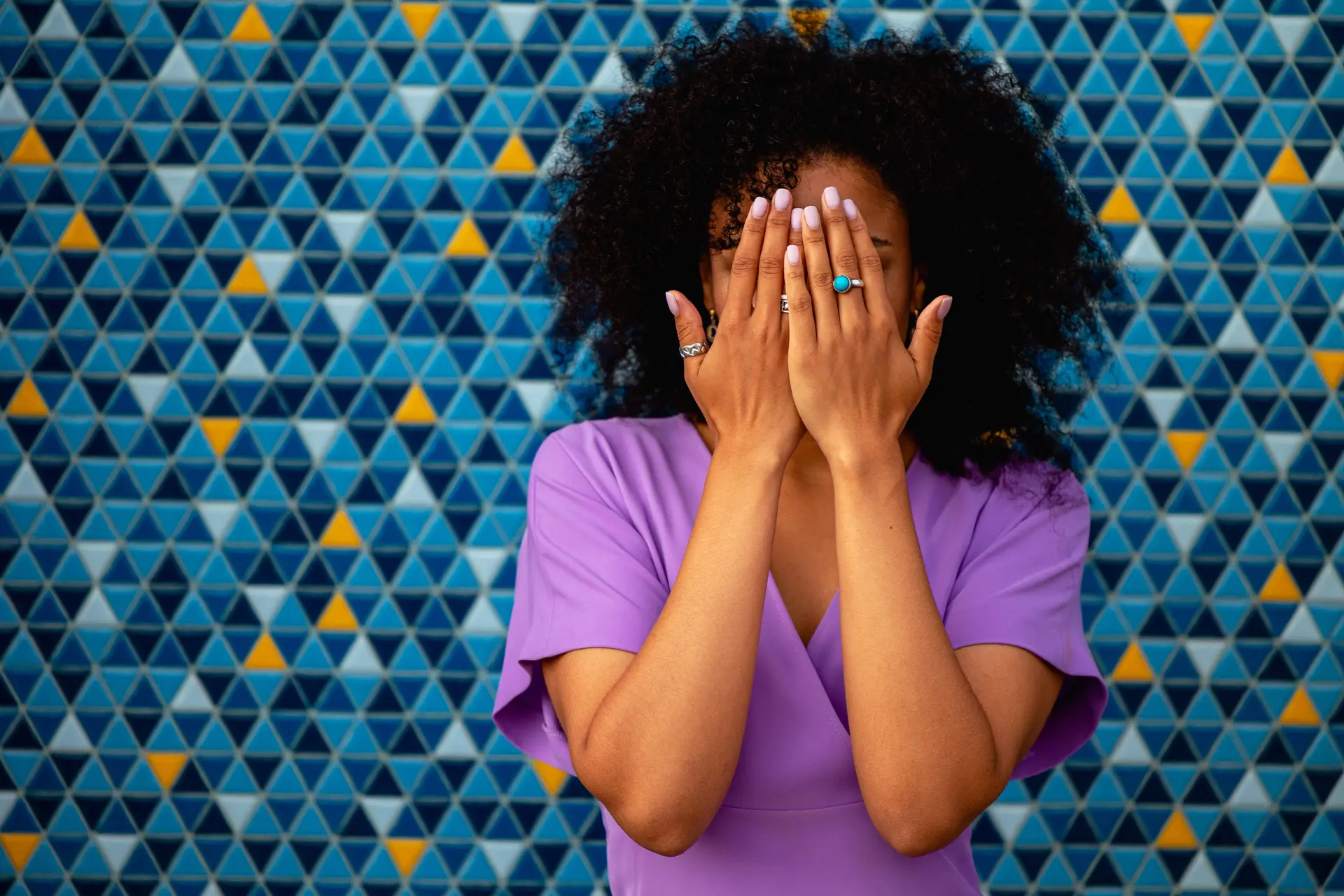Woman covering face.