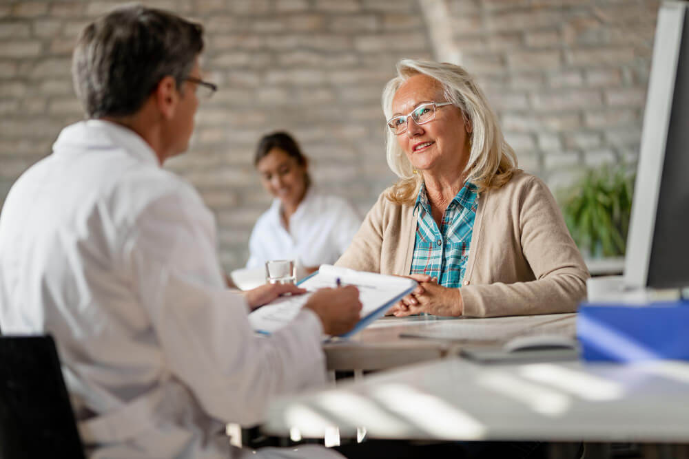Elderly woman discussing health insurance coverage at Los Angeles Therapy Institute